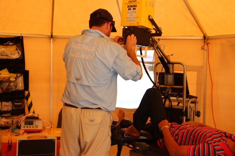 Radiographer performing an x-ray on a patient in a clinical setting